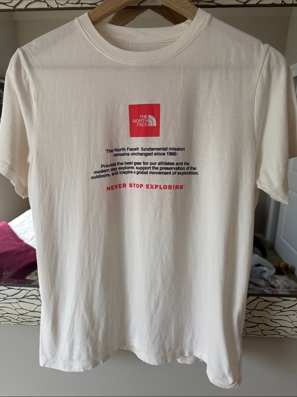 The North Face women’s cotton Tee with logo graphic on front back and left arm